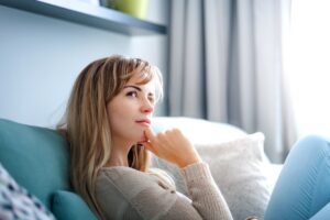 A woman contemplating the cost of procedure she's been wanting.