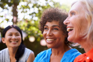 3 women laughing together after taking Bioidentical Hormone Therapy